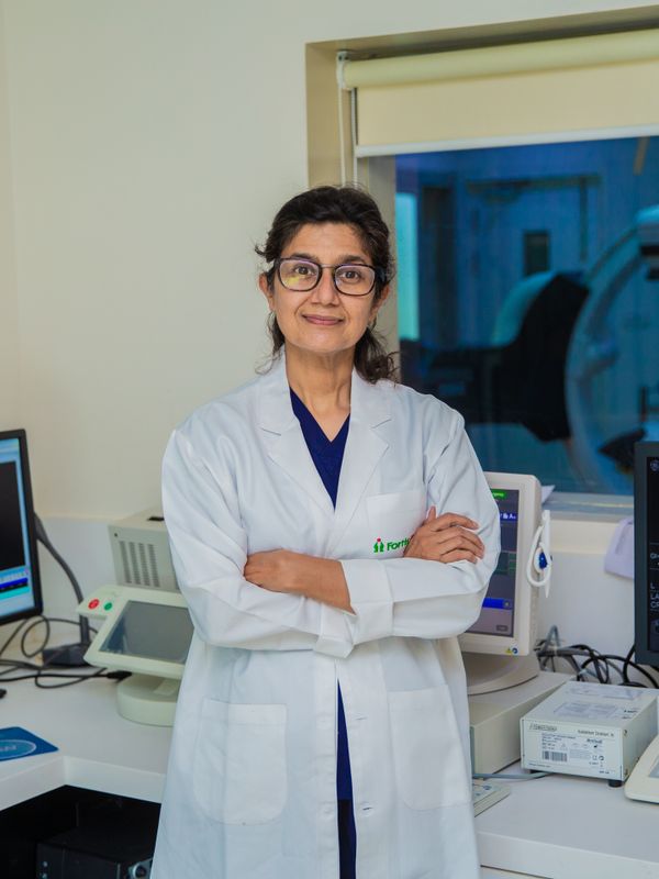 A confident Indian woman doctor in a white coat