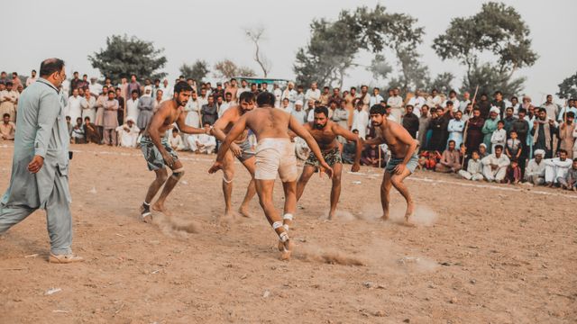 A kabaddi match with a cheering crowd